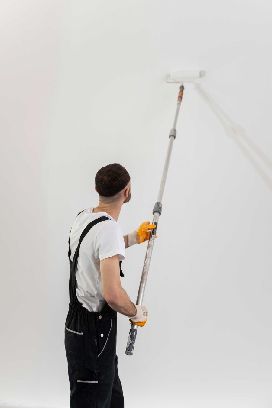Painter rolling a wall
